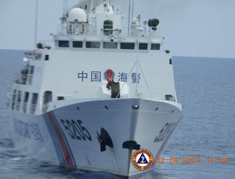 A Chinese coast guard ship pictured near Second Thomas Shoal. It has the number 5205 on the hull. There is monitoring equipment around the bridge and what appears to be a gun on the foredeck.