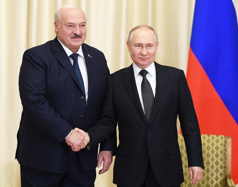 Russian President Vladimir Putin shakes hands with Belarusian President Alexander Lukashenko 