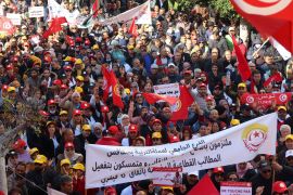 Supporters of the Tunisian General Labour Union (UGTT), carry banners and flags during a protest against President Kais Saied's policies, accusing him of trying to stifle basic freedoms including union rights, in Sfax, Tunisia February 18