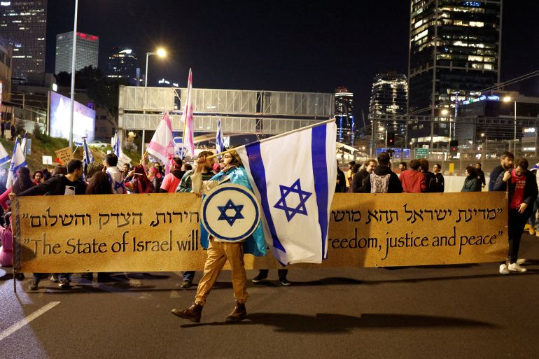 Demonstrators block a road during a protest against Israel's Prime Minister Benjamin Netanyahu