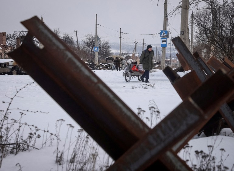 FILE PHOTO: Local residents walk on an empty street, as Russia's attack on Ukraine continues, in the front line city of Bakhmut, Ukraine February 17, 2023.