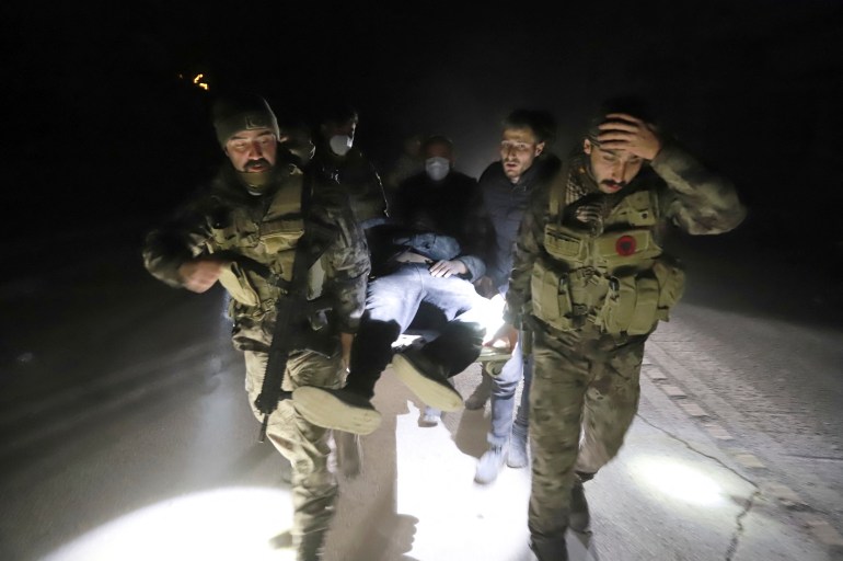 Members of Turkish police special forces carry a wounded man