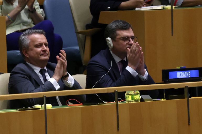 Ukraine's foreign minister and UN ambassador applaud after the resolution was passed. They look pleased.