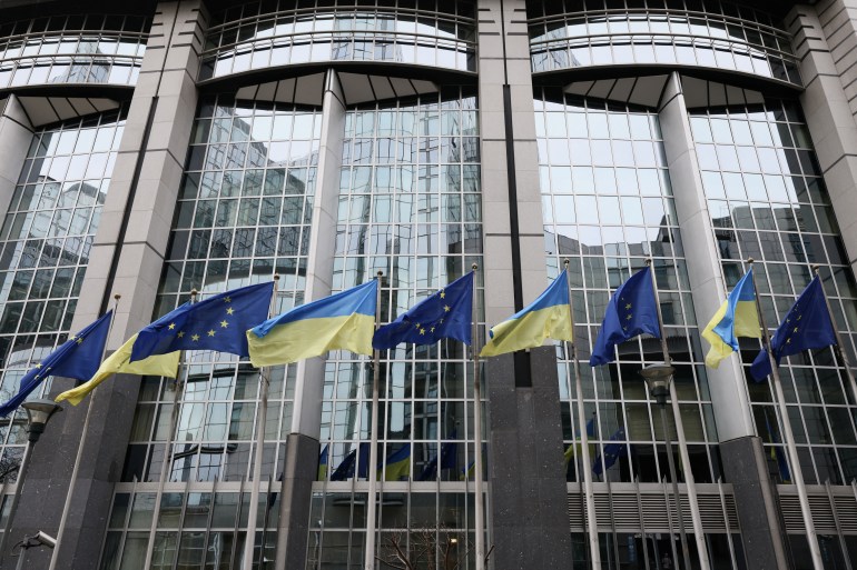 Flags of Ukraine fly in front of the EU Parliament building in Brussels