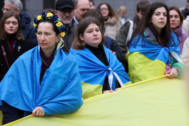 Supporters of Ukraine hold a minute of silence in front of the EU Parliament building on the first anniversary of the Russian invasion, in Brussels, Belgium February 24, 2023. REUTERS/Yves Herman