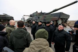 Ukrainian Prime Minister Denys Shmyhal and Polish Prime Minister Mateusz Morawiecki speak to Polish service members next to the first Leopard 2 tanks delivered from Poland on a day of the first anniversary of Russia's attack on Ukraine, in an undisclosed location, Ukraine February 24, 2023. Ukrainian Governmental Press Service/Handout via REUTERS ATTENTION EDITORS - THIS IMAGE WAS PROVIDED BY A THIRD PARTY. REFILE - QUALITY REPEAT