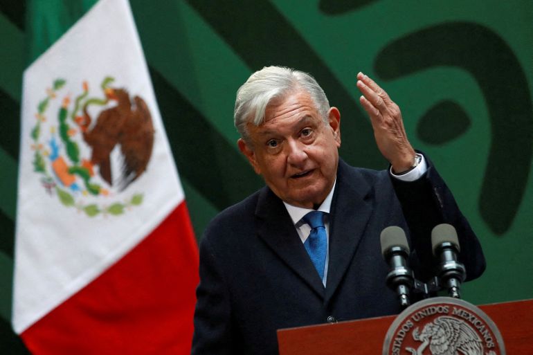 Andres Manuel Lopez Obrador speaks from a lectern at a press conference in Mexico City. A flag of Mexico is behind him.