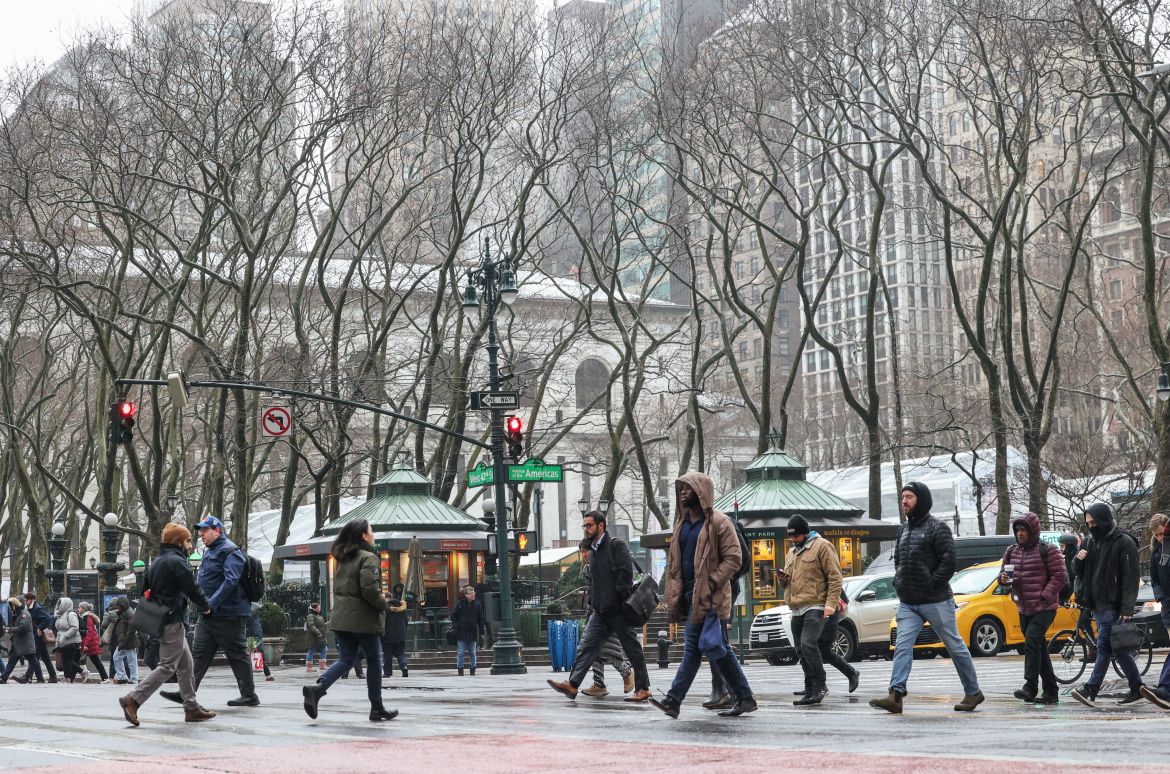 People make their way through a wintry mix near Bryant Park during a storm in New York City