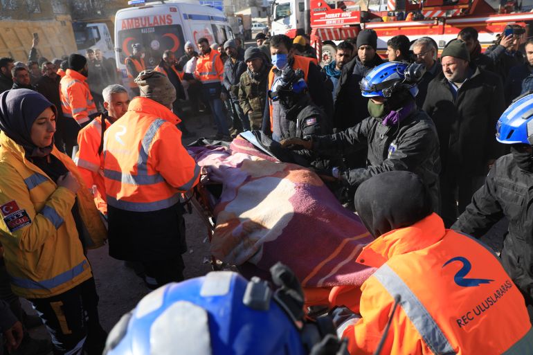 Rescue workers from Turkey and Malaysia carry out a person retrieved from a collapsed building in Nurdagi, Gaziantep