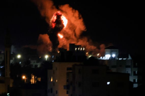 A column of smoke and fire in the night sky over Gaza.