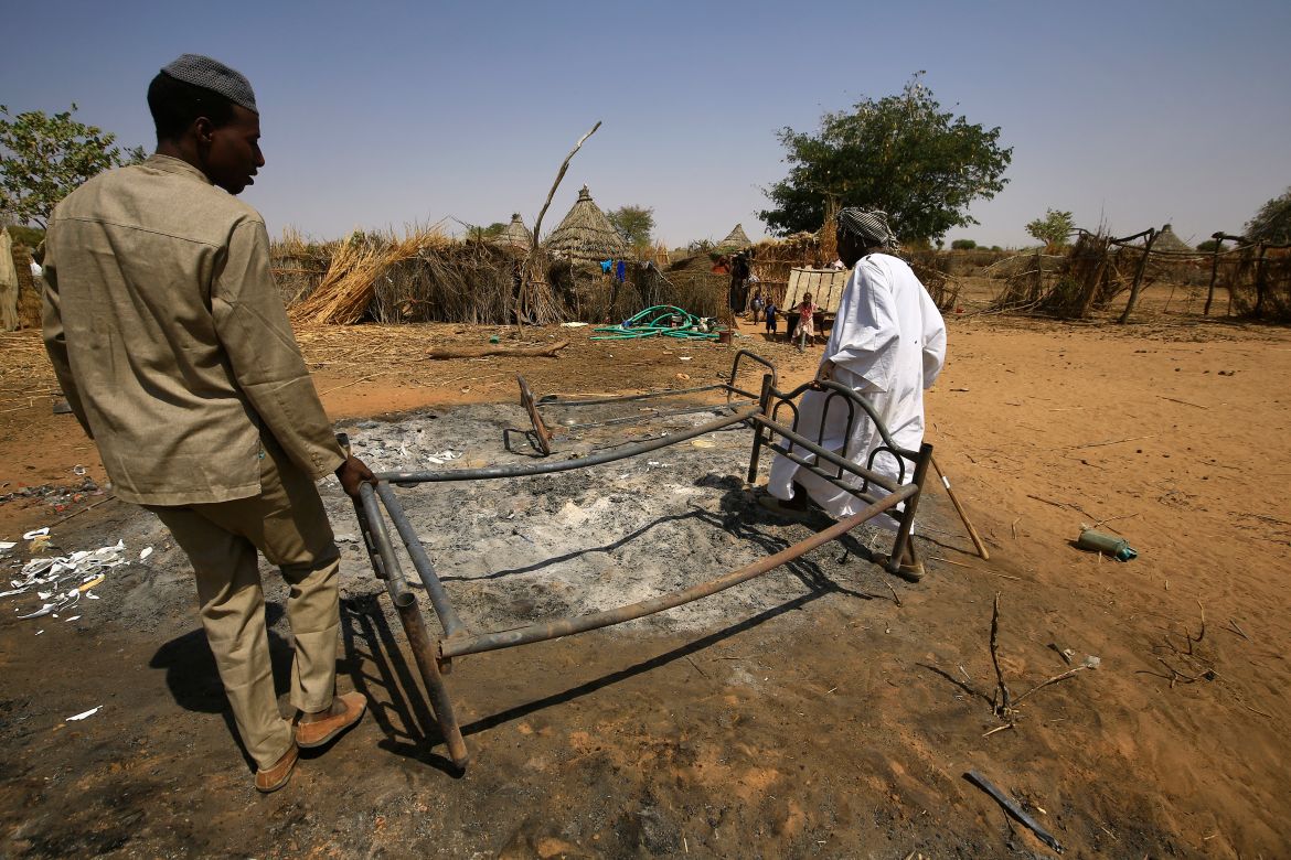 Sudanese check the aftermath of violence in the village of al-Twail Saadoun, 85 kilometres south of Nyala town