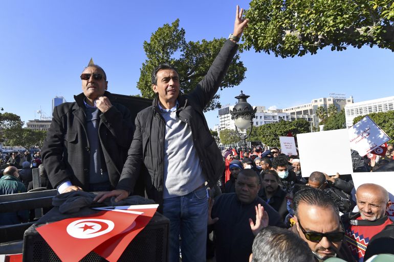 Jawhar Ben Mbarek, a member of the "Citizens Against Coup" campaign, gestures during a demonstration against President Kais Saied on December 17, 2021 in the capital Tunis, on the 11th anniversary of the start of the 2011 revolution. - Opponents of Tunisian President Kais Saied slammed his decision to extend a months-long suspension of parliament, accusing him of dealing another blow to the country's nascent democracy. (Photo by FETHI BELAID / AFP)