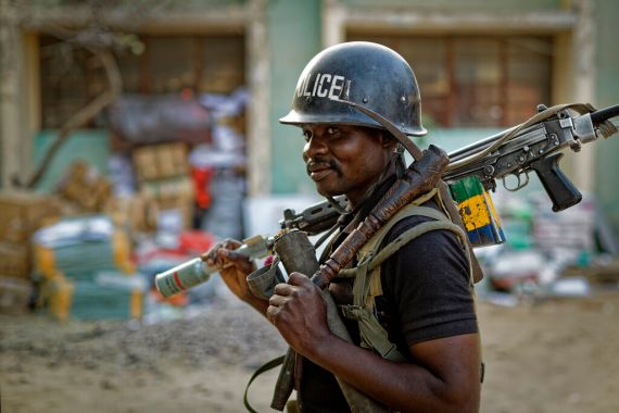 A Nigerian policeman provides security at the offices of the Independent National Electoral Commission in Kano, northern Nigeria in 2019 [File: Ben Curtis/AP Photo]