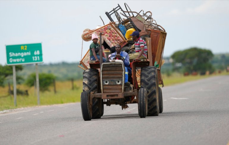 A tractor is seen transporting farm workers in Zimbabwe