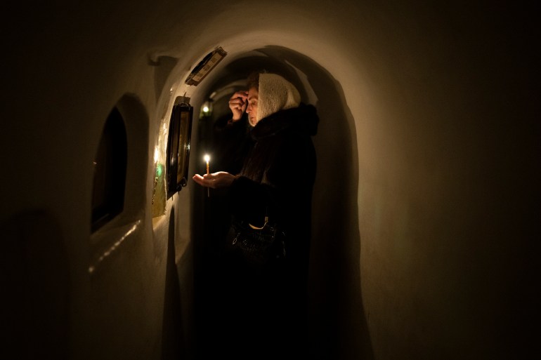 Woman prays at a monastery