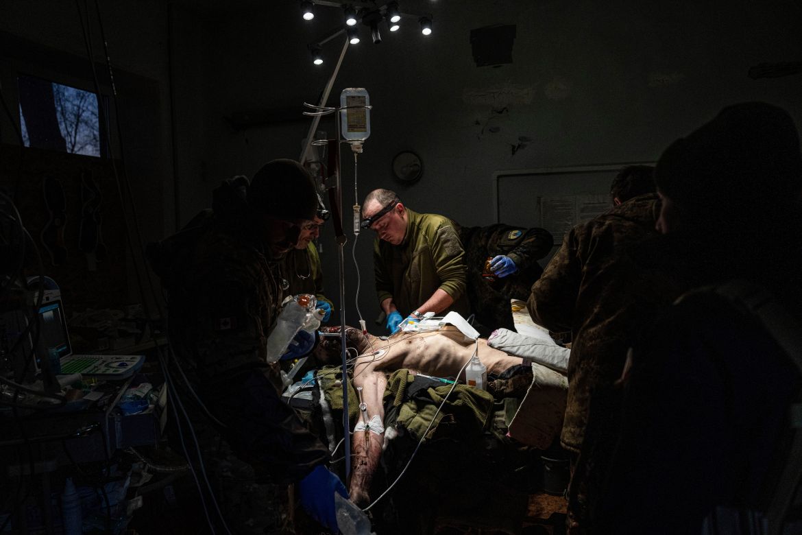 Ukrainian military doctors treat an injured comrade who was evacuated from the battlefield at the hospital in Donetsk region
