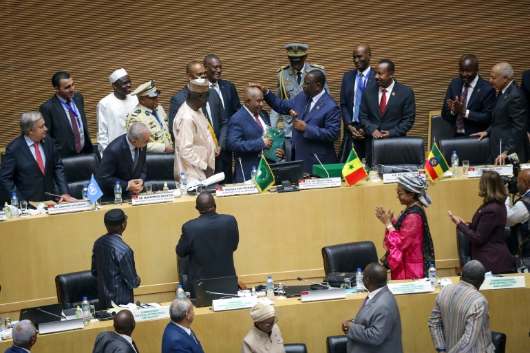 From top left, Secretary-General of the United Nations Antonio Guterres, Palestinian Prime Minister Mohammad Shtayyeh, African Union Commission Chairman Moussa Faki Mahamat, Comoros President Azali Assoumani, Senegal President Macky Sall, Ethiopia President Abiy Ahmed, and Secretary-General of the Arab League Ahmed Aboul-Gheit, attend the ceremony to appoint Assoumani as the new African Union (AU) chairperson, in Addis Ababa, Ethiopia Saturday, Feb. 18, 2023. The 36th African Union Summit is taking place in the Ethiopian capital this weekend. (AP Photo)