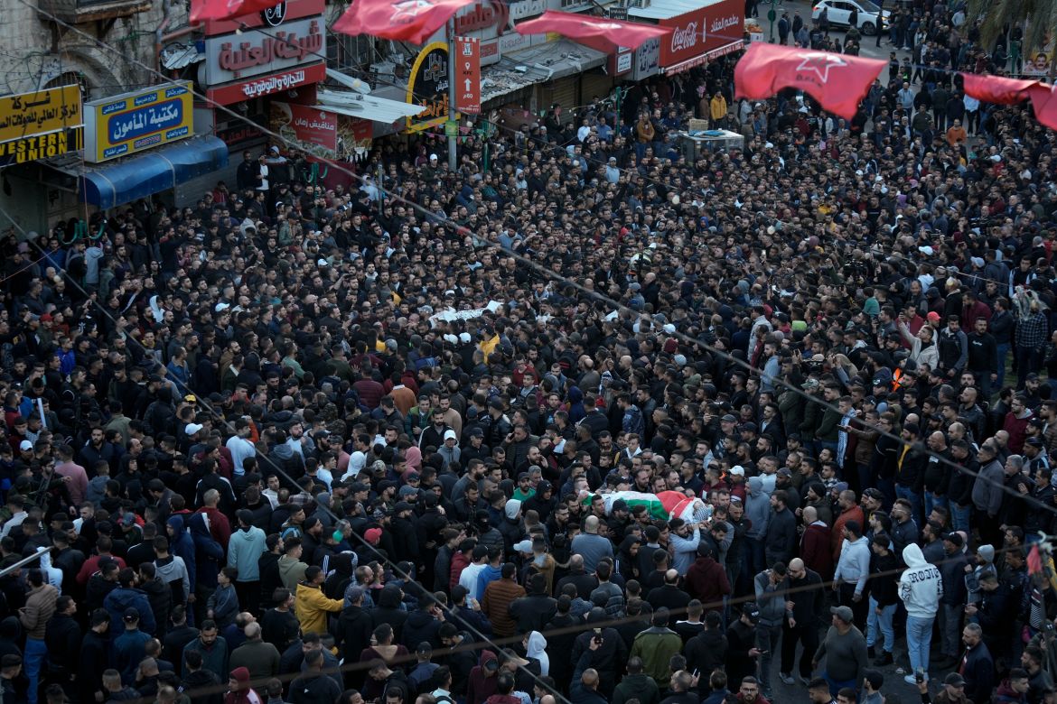 Palestinians carry the bodies of 10 men killed by Israeli forces