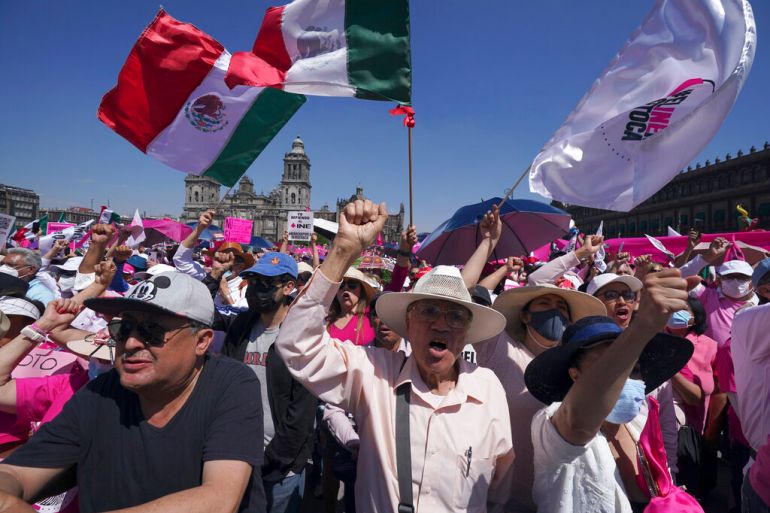 Antigovernment demonstrators shout slogans against Mexican President Andres Manuel Lopez Obrador, during a march against recent reforms to the country's electoral law that they say threaten democracy, in Mexico City's main square, The Zocalo.