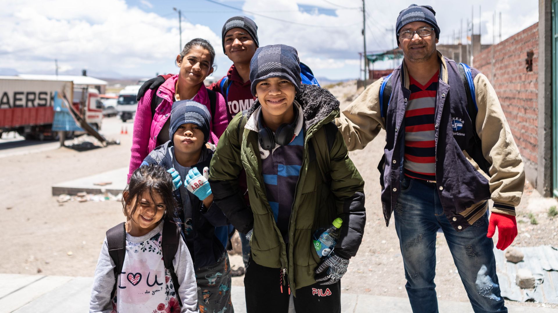 With Allyson — the smallest member of the family — standing in front, three of her siblings plus her parents pose in the desert-like roads on the Bolivian-Chilean border.