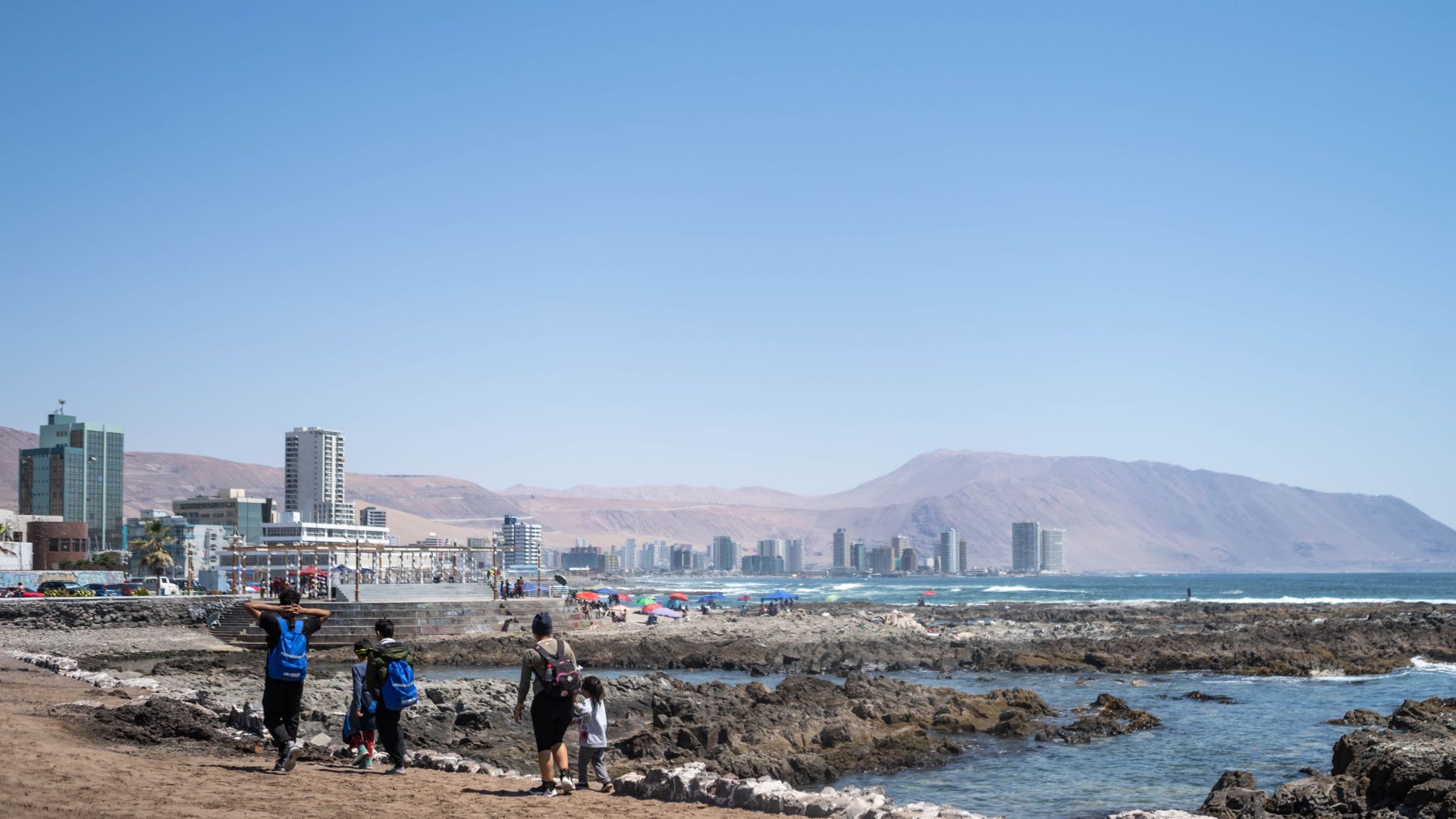 Allyson and her family walk along the shores in Iquique, Chile.