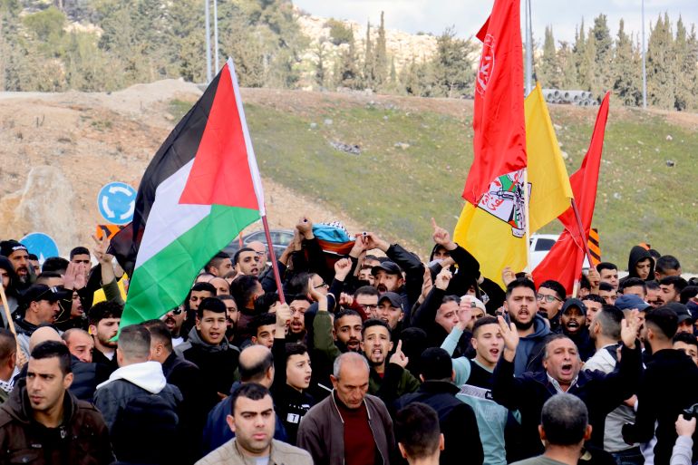 Hundreds of mourners carried Mohammad Jawabreh's shrouded body, covered with the Palestinian flag