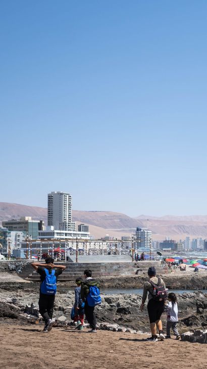 Allyson and her family walk along the shores of Iquique, Chile.