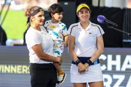 CLEVELAND, OH - AUGUST 27: Sania Mirza of India, her son and Christina McHale of the United States are interviewed after winning in the second set of their semifinal doubles match against Ulrikke Eikeri of Norway and Catherine Harrison of the United States on day 6 of the Cleveland Championships at Jacobs Pavilion on August 27, 2021 in Cleveland, Ohio. Lauren Bacho/Getty Images/AFP (Photo by Lauren Bacho / GETTY IMAGES NORTH AMERICA / Getty Images via AFP)