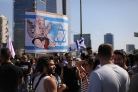 Protesters holding up humurous signs against Netanyahu in Tel Aviv