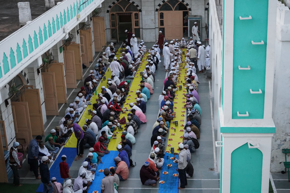 A view of the gathering of people while breaking the fast in a mosque in New Delhi. In almost all mosques in Delhi, the mosque administration usually arranges for food to be served to people for breaking their fasts before evening prayers.