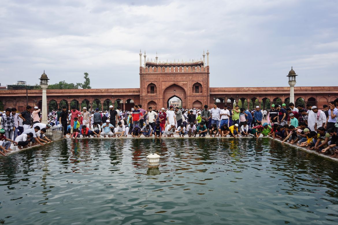 People performing wudu (ablution), a mandatory body washing ritual before any prayer among Muslims, in a pool ahead of Friday prayers in the Jama Masjid.