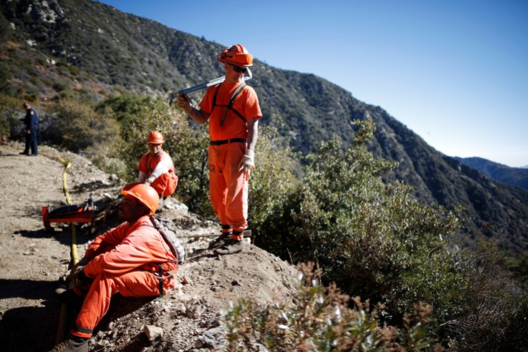 Prison inmates lay water pipe on a work project outside Oak Glen Conservation Fire Camp #35 in Yucaipa, California 