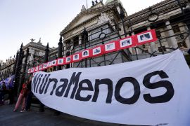 A banner that reads 'Not another (woman) less' is placed on the fence of Argentina's Congress