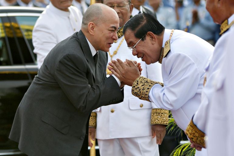Cambodia's King Norodom Sihamoni is greeted by prime minister Hun Sen