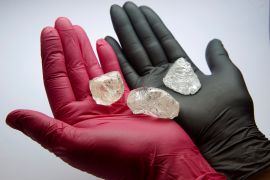 An employee shows gem-quality stones, including a rare 242-carat rough diamond that will be offered at the 100th international auction of Russian state-controlled diamond producer Alrosa, during a presentation in Moscow, Russia February 25, 2021. The diamond is one of the biggest gem-quality stones Alrosa has mined this century, the company said. Picture taken February 25, 2021. REUTERS/Tatyana Makeyeva TPX IMAGES OF THE DAY