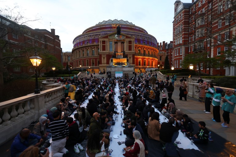 Muslims break their fast at an open Iftar, during the fasting month of Ramadan, outside the Royal Albert Hall in London, Britain April 13, 2022. REUTERS/Hannah McKay