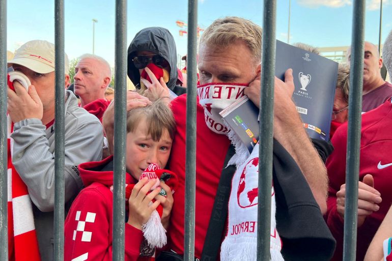 Liverpool fans react as they queue to access Stade de France before Champions League Final