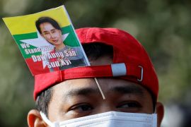 A protester uses a flag with an image of deposed Myanmar leader Aung San Suu Kyi during a rally to mark the second anniversary of Myanmar&#39;s 2021 military coup, outside the Embassy of Myanmar in Tokyo, Japan on February 1, 2023 [File: Issei Kato/ Reuters]