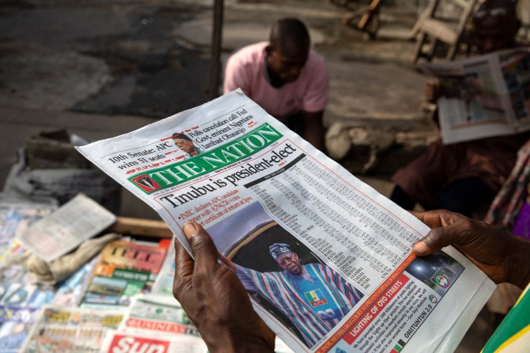 A man reads a newspaper after Bola Ahmed Tinubu was declared the winner and president-elect of Nigeria after elections disputed by opposition parties in Lagos, Nigeria, March 1, 2023. REUTERS/James Oatway