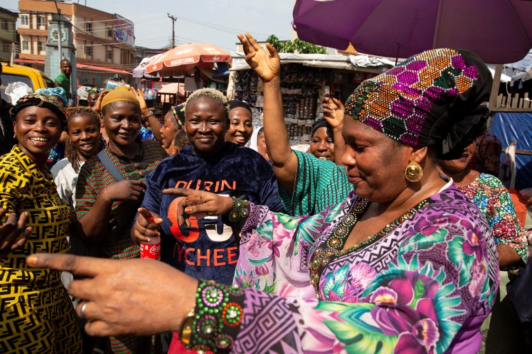 Women dance in celebration of Bola Ahmed Tinubu's victory in an election that has been disputed by opposition parties, at a market in Lagos, Nigeria March 1