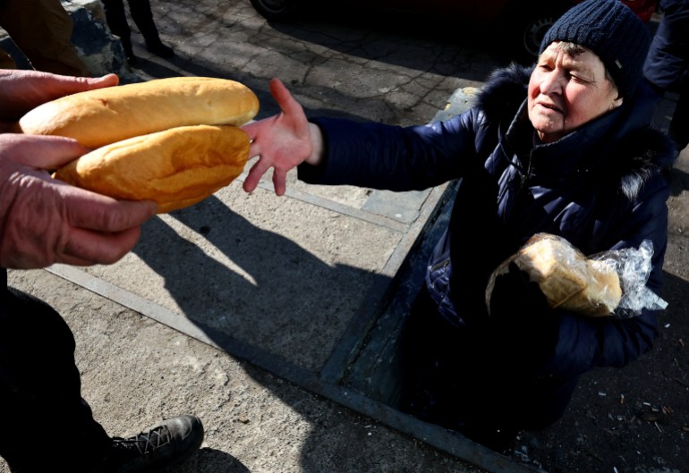 Woman being handed food 