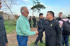 Ivan Velasquez shakes a police officer's hand