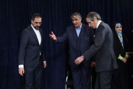 Head of Iran's Atomic Energy Organization Mohammad Eslami and International Atomic Energy Agency (IAEA) Director General Rafael Grossi arrive at a news conference