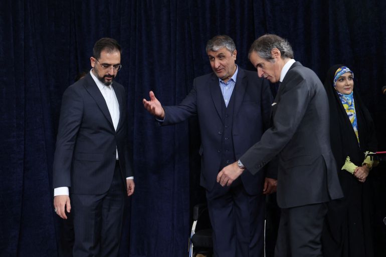 Head of Iran's Atomic Energy Organization Mohammad Eslami and International Atomic Energy Agency (IAEA) Director General Rafael Grossi arrive at a news conference