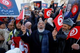 Supporters of Tunisia's Salvation Front opposition coalition gesture during a protest over the arrest of some of its leaders and other prominent critics of the president, in Tunis