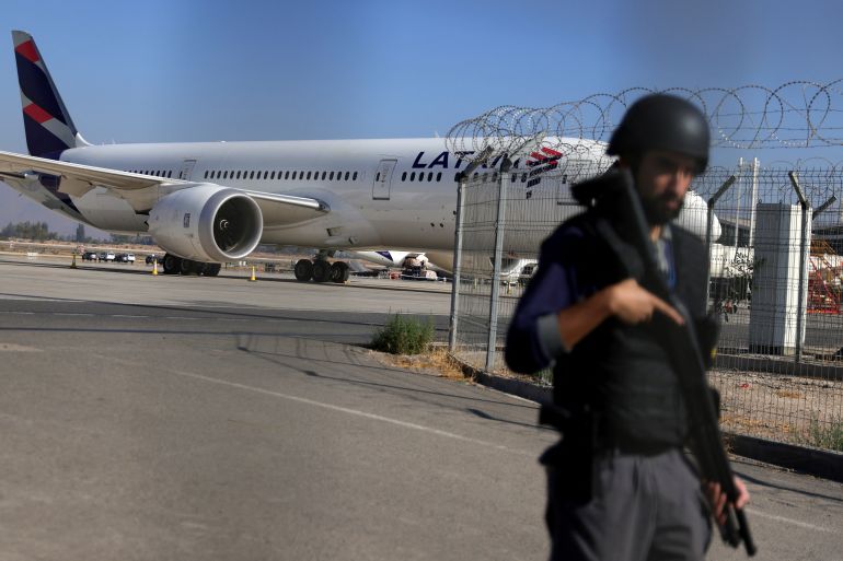 A security officer stands guard outside of the Santiago airport