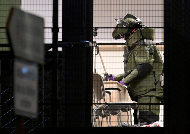 A member of a bomb disposal squad, in specialist clothing, pictured inside the centre.