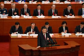 XI Jinping addressing delegates to the NPC from a lectern during the closing session at the Great Hall of the People in Beijing.