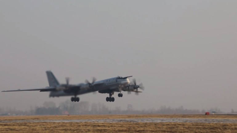 A Russian Tu-95MS strategic bomber takes off in an unknown location to perform a flight over the neutral waters of the Sea of Japan, in this still image taken from video released March 21, 2023. Russian Defence Ministry/Handout via REUTERS ATTENTION EDITORS - THIS IMAGE WAS PROVIDED BY A THIRD PARTY. NO RESALES. NO ARCHIVES. MANDATORY CREDIT.