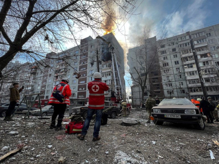 Paramedics and rescuers work at a site of a residential building 